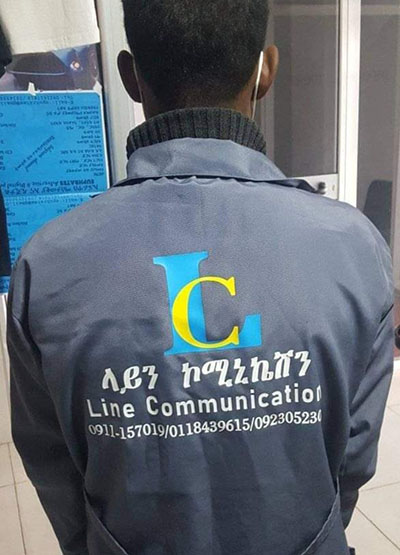 Alemu Guchale with uniform titled line communicaions